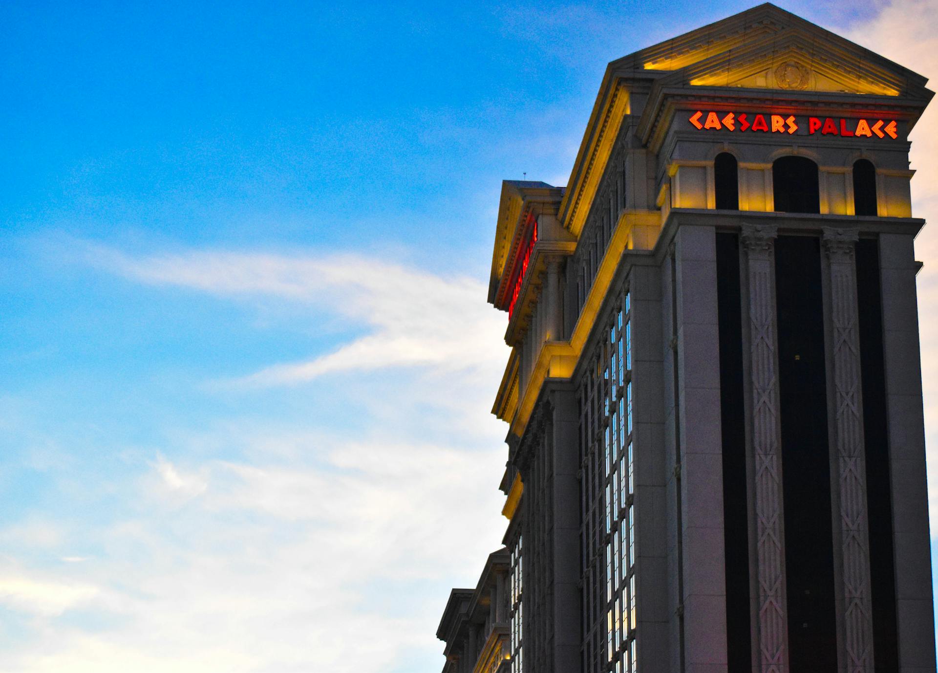 Captivating view of Caesars Palace against a vibrant Las Vegas sunset sky.