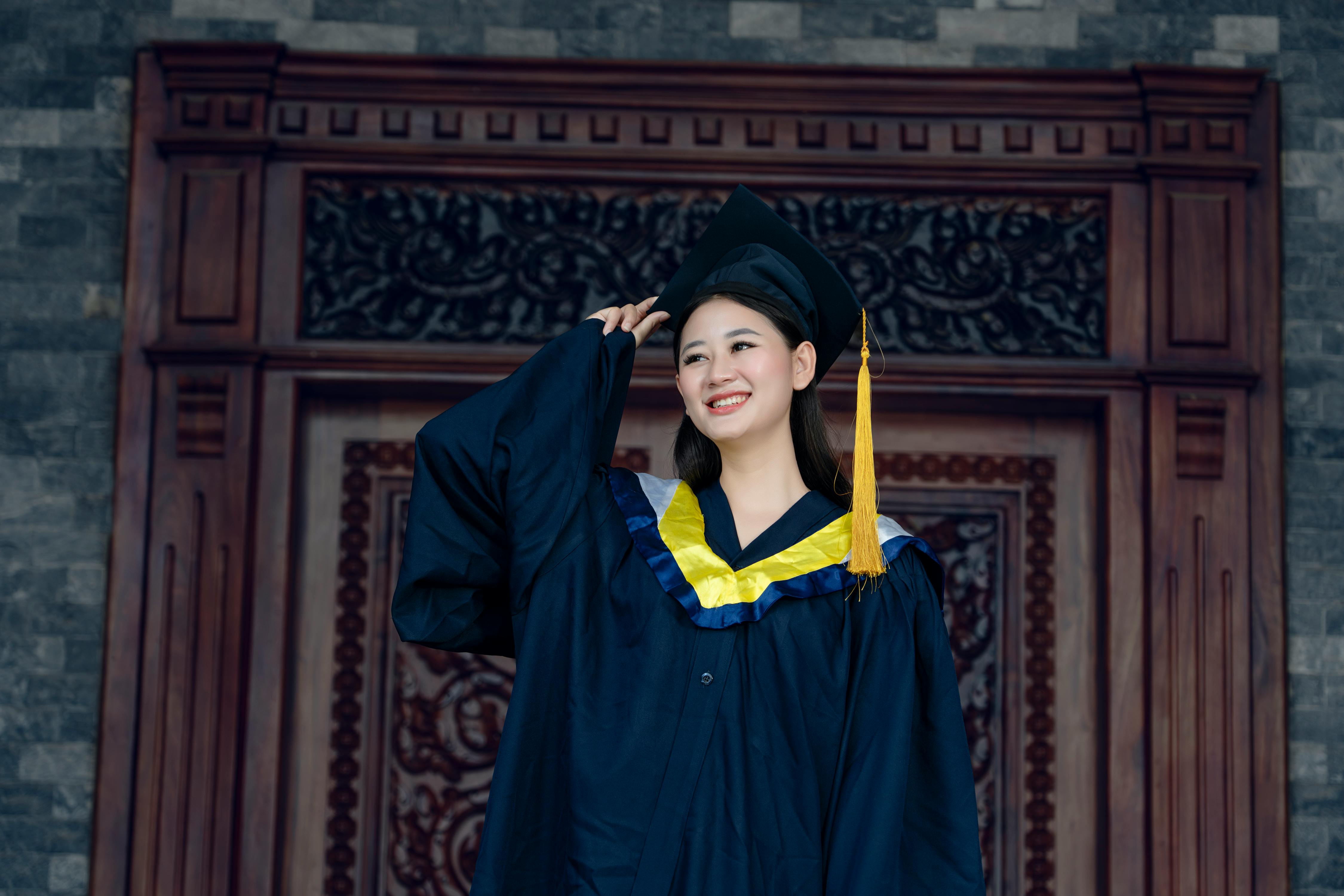 a woman in a graduation gown posing for the camera