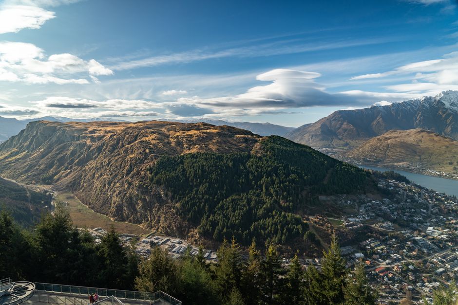 Spectacular Milford Sound Helicopter and Cruise Tour from Queenstown Review Review 2026 - Breathtaking aerial view of Queenstown, New Zealand showcasing lush mountains and vibrant townscape.