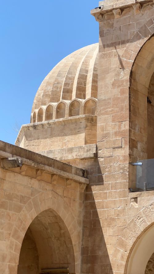 Free Detailed view of an ancient stone building featuring arches and a dome. Stock Photo