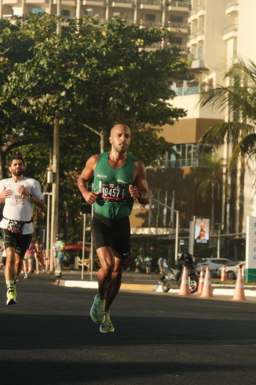Free Runners in action during a marathon in Rio de Janeiro, showcasing determination and athleticism. Stock Photo