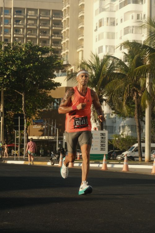 Free Athletic man running a marathon in sunny Rio de Janeiro street scene. Stock Photo