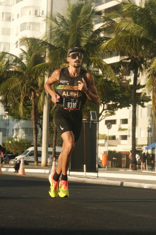 Free Male athlete running a marathon on a sunny day at Copacabana Beach, Rio. Stock Photo