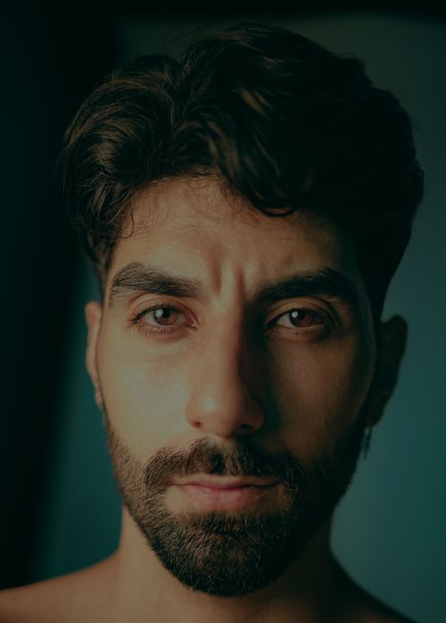 Free Close-up portrait of a serious bearded man indoors with dramatic lighting and expressions. Stock Photo