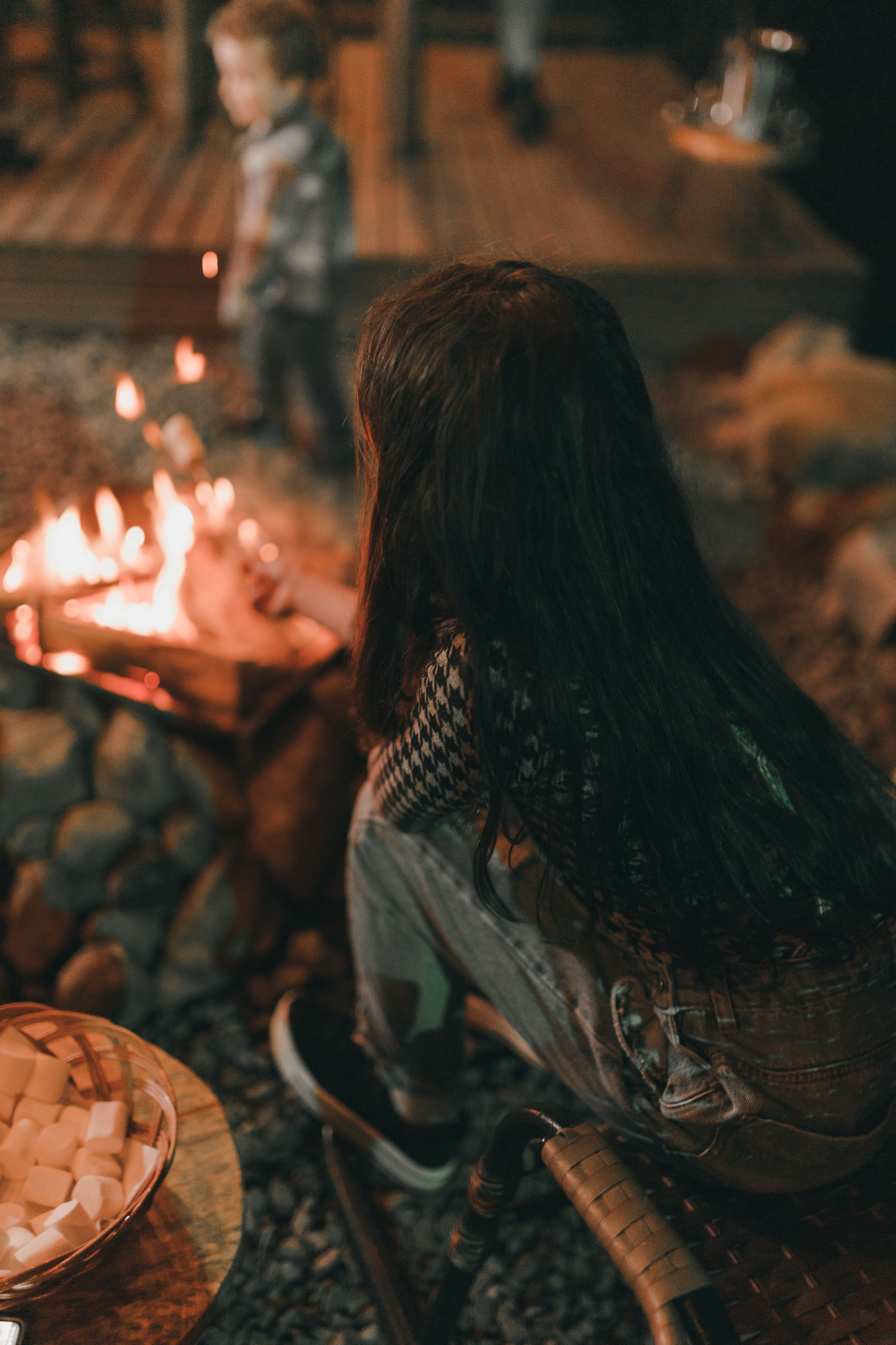 A family enjoys an evening by the backyard fire, creating warmth and memories.
