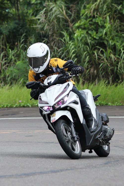 A person riding a motorcycle on a road · Free Stock Photo