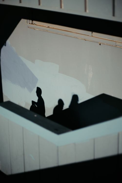 Free Abstract silhouette of three people against Istanbul building, capturing urban light and shadow play. Stock Photo