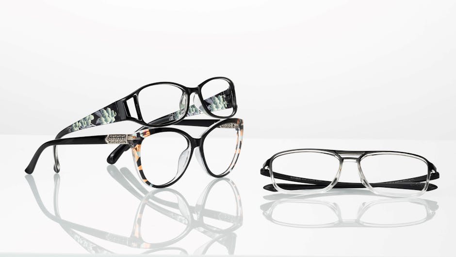 Elegant collection of modern glasses with stylish frames on a reflective surface.