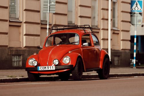 Free A vintage red Volkswagen Beetle parked on a city street in Jönköping, Sweden. Stock Photo