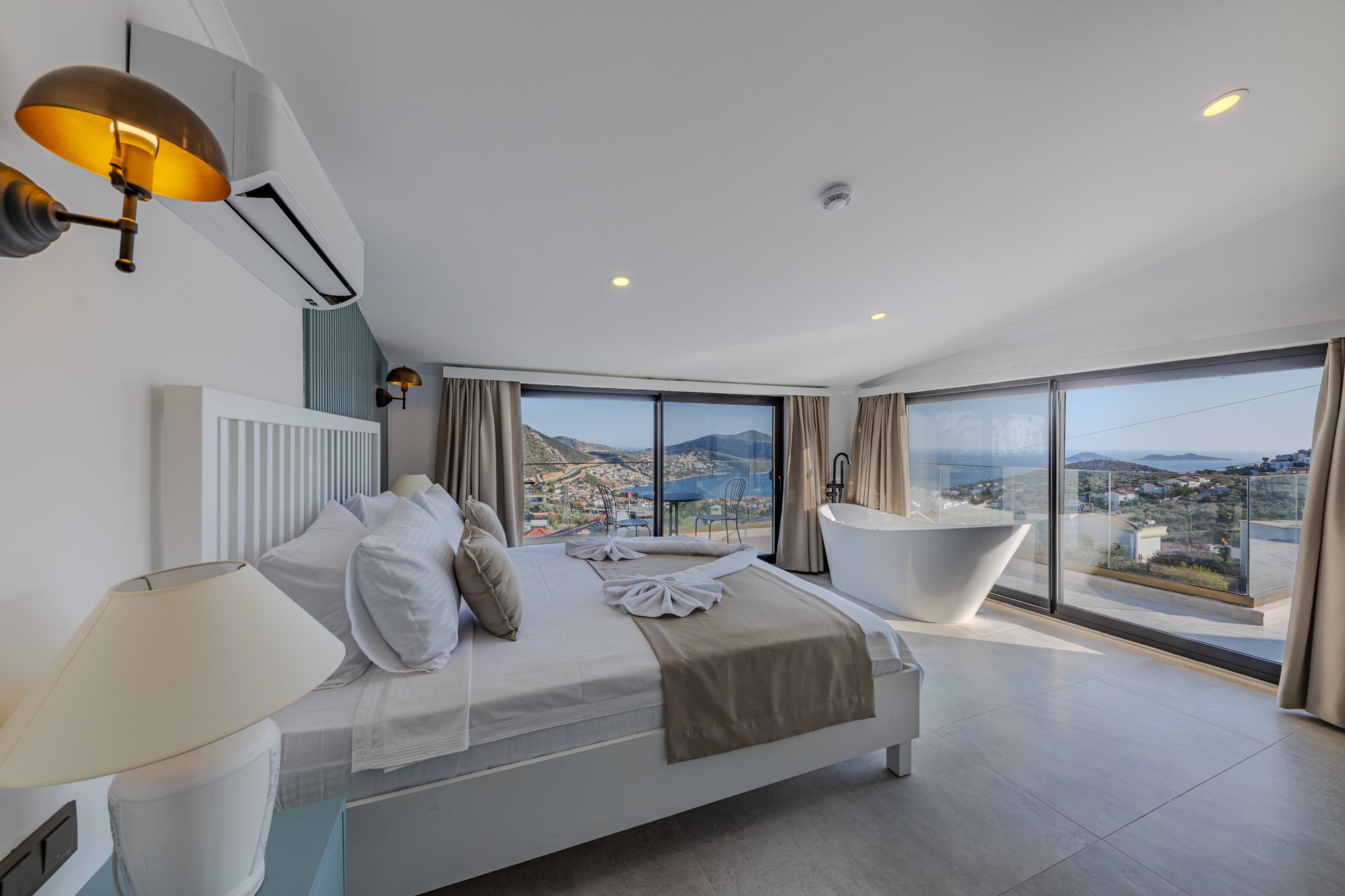 Spacious primary bedroom with pale finishes