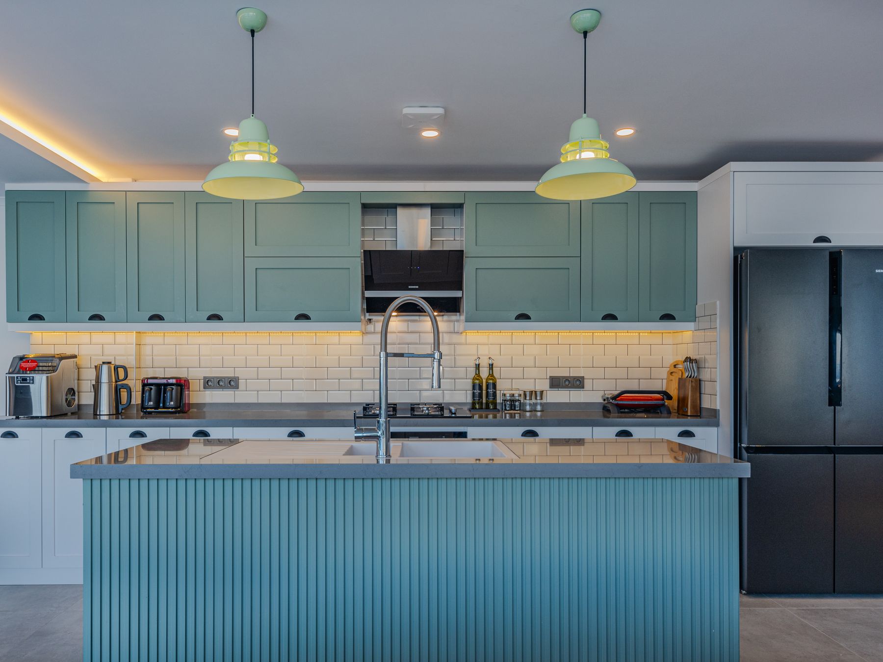 Kitchen Spraying in Shepherds Bush — careful masking before painting begins