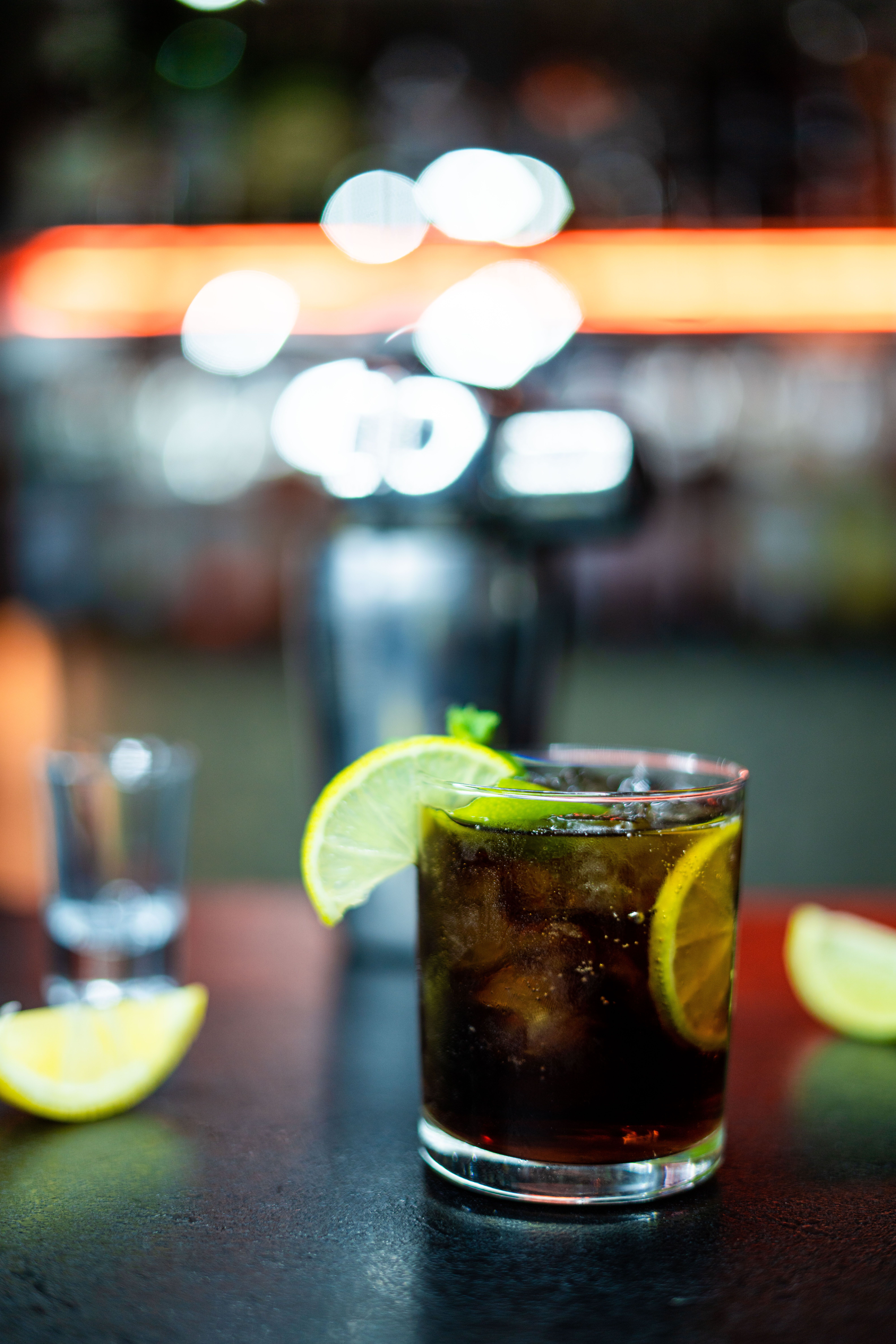 A glass of cola with lemon wedges and a lime · Free Stock Photo