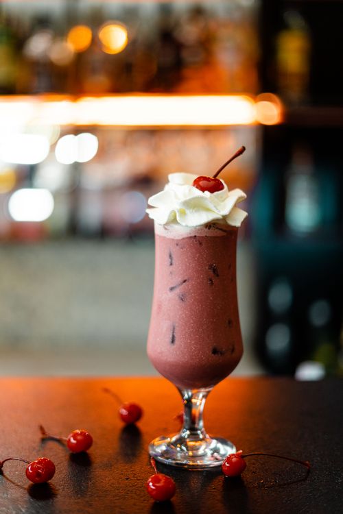 Free A rich chocolate milkshake topped with whipped cream and a cherry, perfect for dessert lovers. Stock Photo