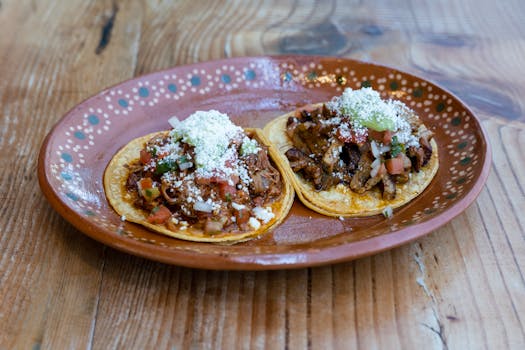 Delicious authentic Mexican tacos served on a traditional plate, showcasing vibrant flavors.