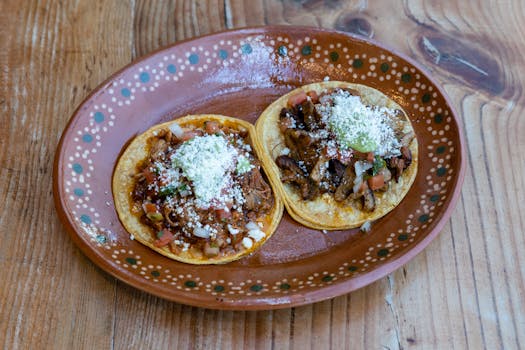 Close-up of authentic Mexican tacos served on a traditional handmade plate, perfect for food photography.
