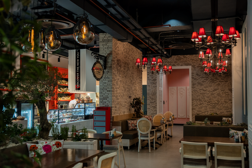 Free Inviting cafe interior in Erbil featuring elegant chandeliers and cozy seating arrangement. Stock Photo