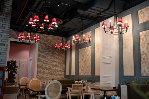 Free A beautifully designed cafe interior in Erbil, showcasing chandeliers and stylish furniture. Stock Photo