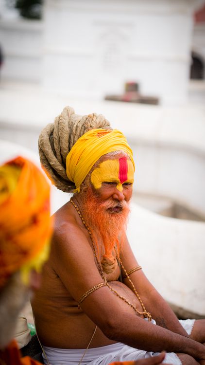 A man with a yellow beard and turban sitting on a bench · Free Stock Photo