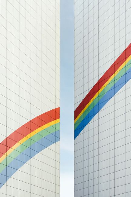 A striking view of modern architecture featuring a rainbow pattern on a Berlin building.