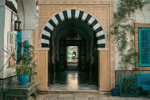 Free Explore a peaceful Tunisian courtyard with traditional architecture in Carthage, Tunisia. Stock Photo