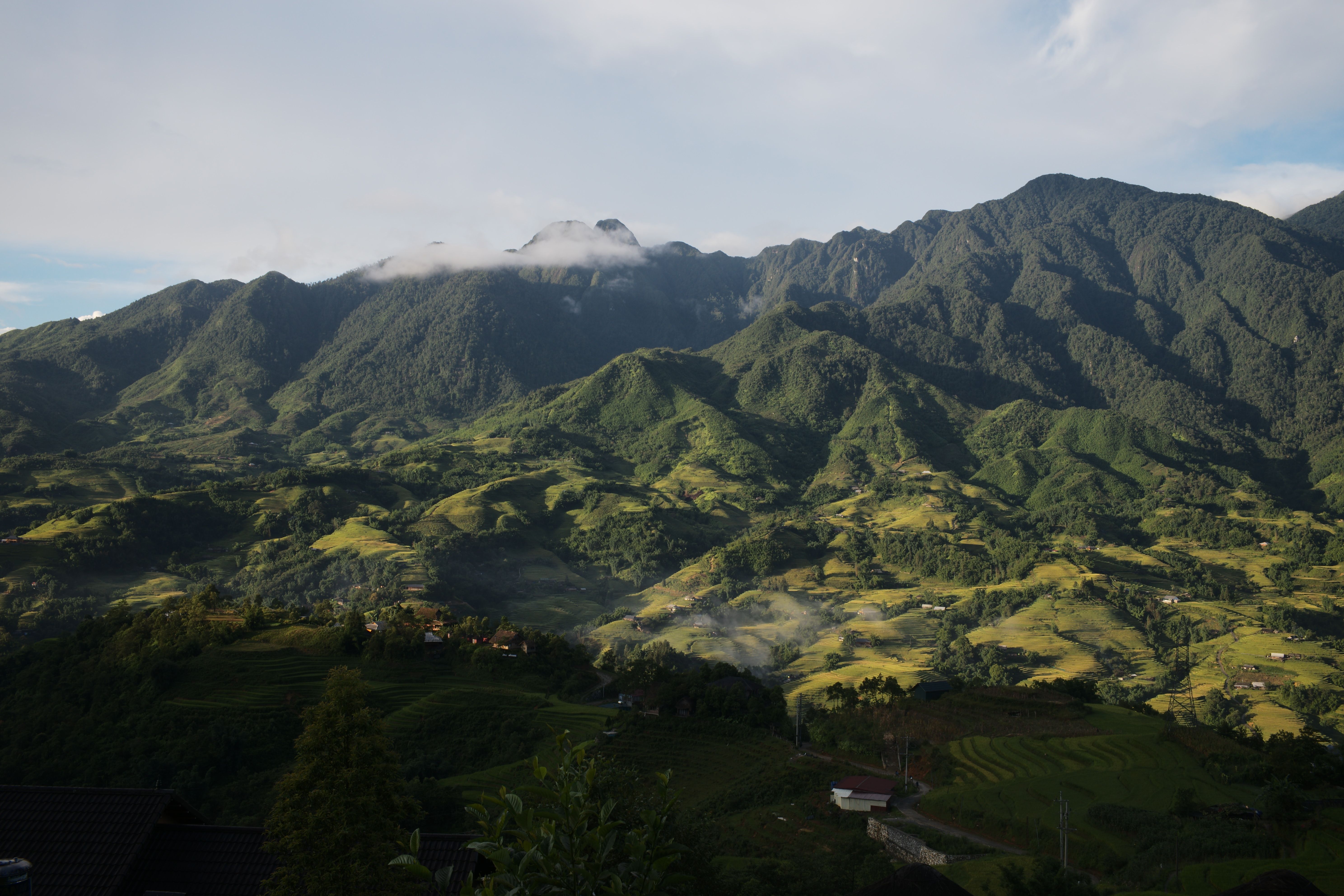 Breathtaking view of Lào Cai mountains with lush green valleys and misty peaks.
