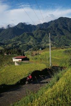 Captivating landscape of Sapa, Vietnam with lush green fields and distant mountains, ideal for travel enthusiasts.