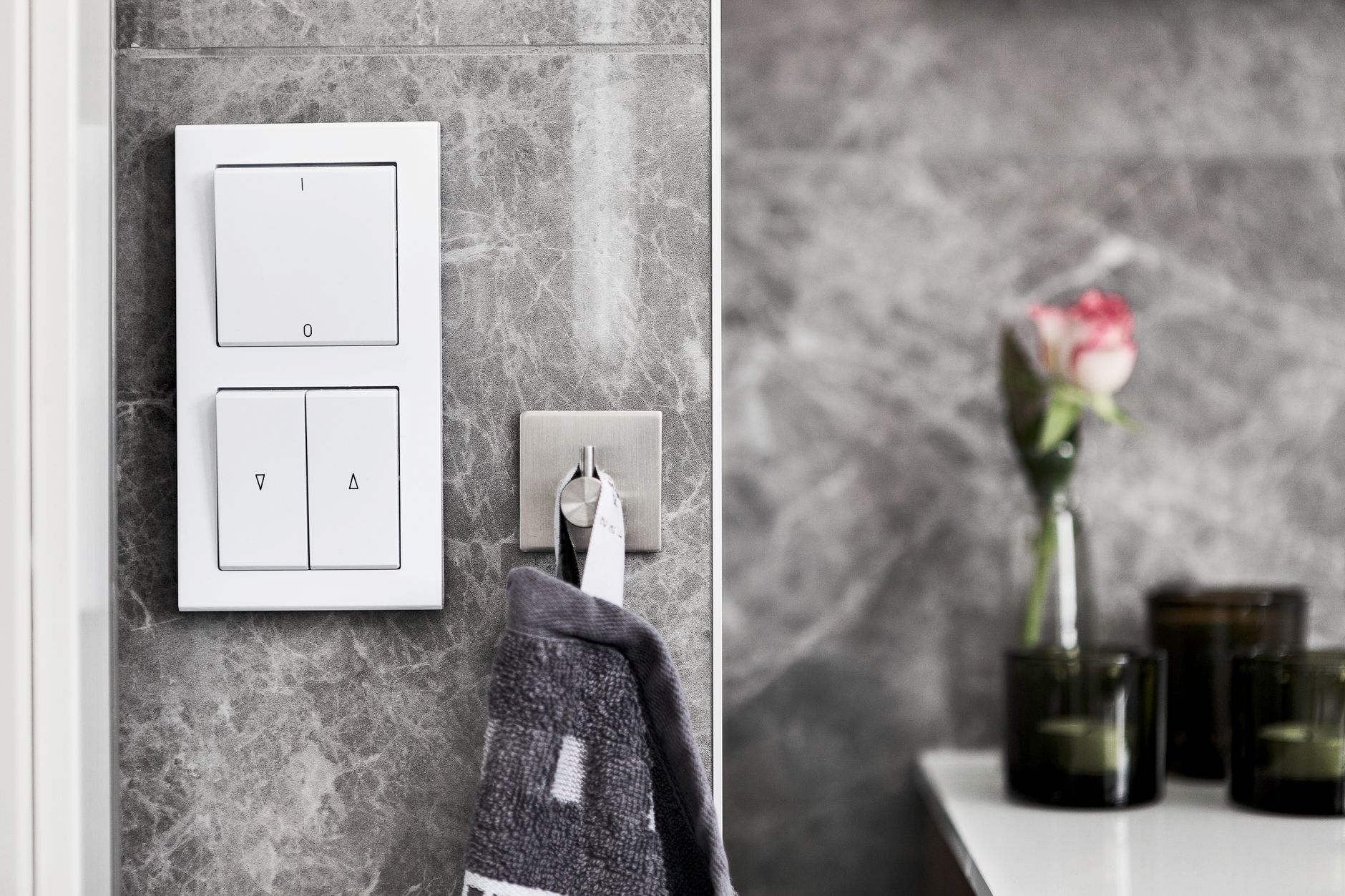 luxury bathroom transformation with smart home gadgets Elegant bathroom featuring marble wall, switch, and minimalist decor.
