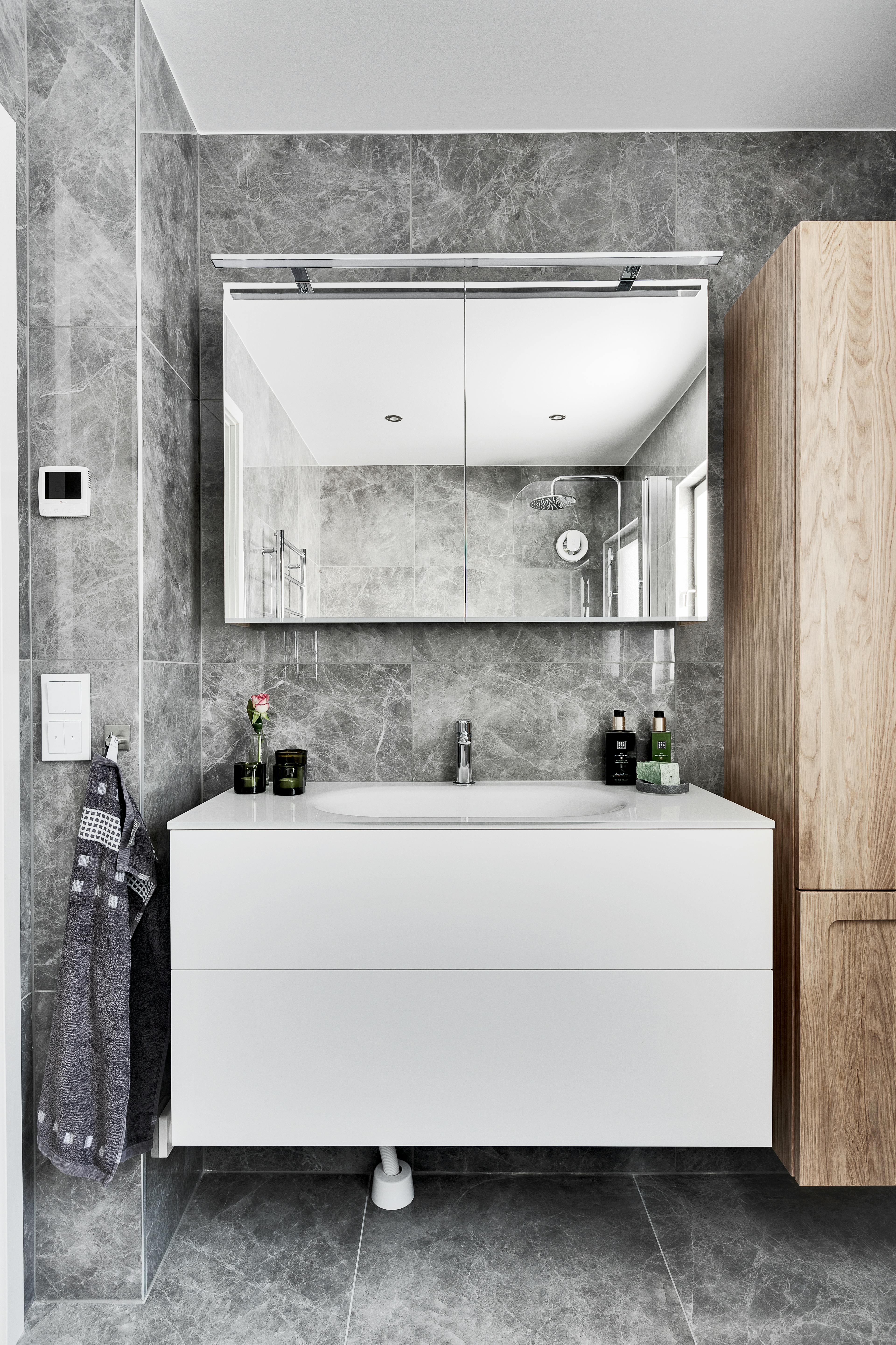 Warm wood vanity with stone countertop and minimalist fixtures