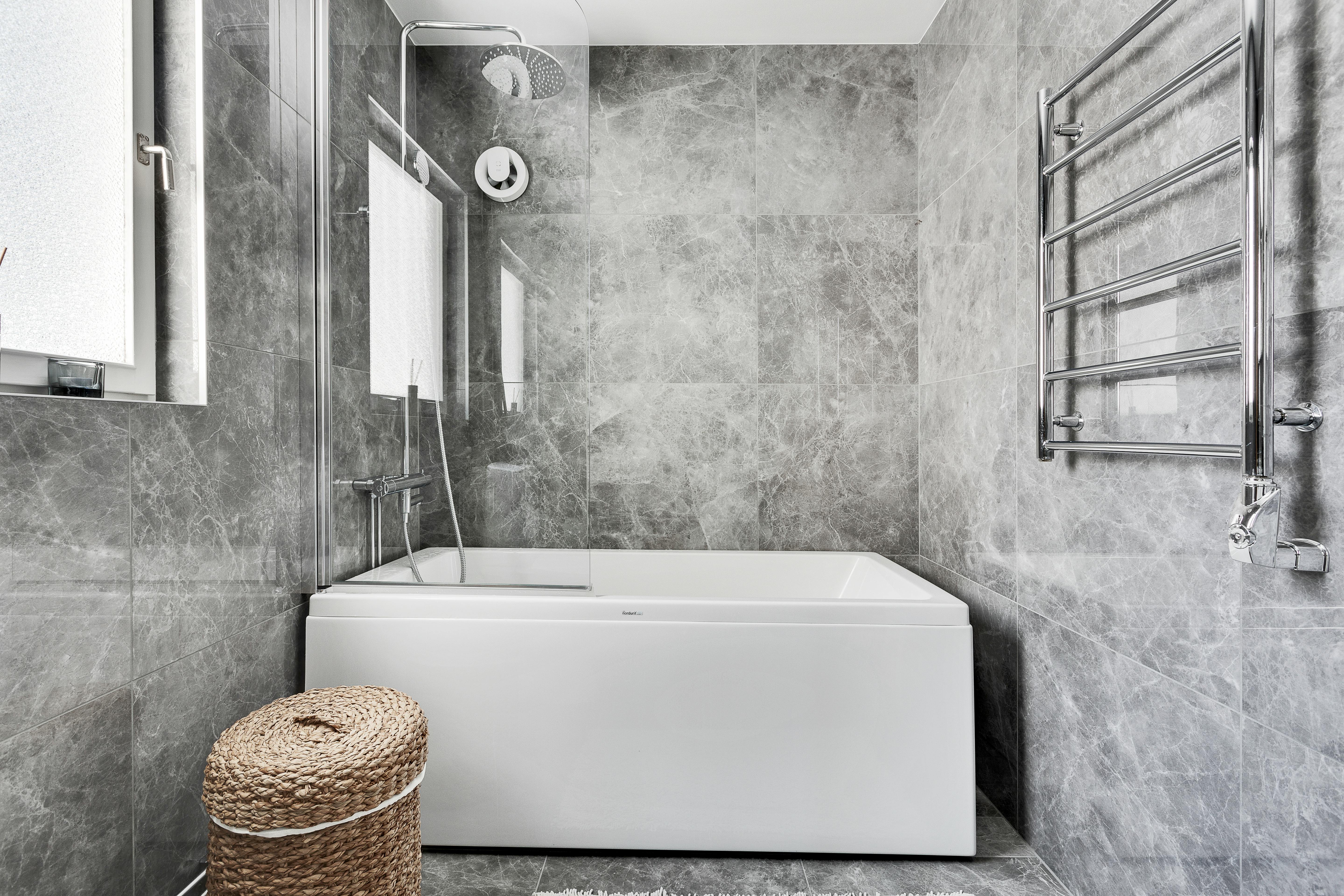 A traditional tub and shower combo in a stylish residential bathroom