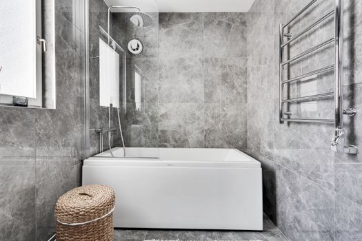 Explore a sleek and contemporary gray marble bathroom with elegant fixtures and abundant natural light.
