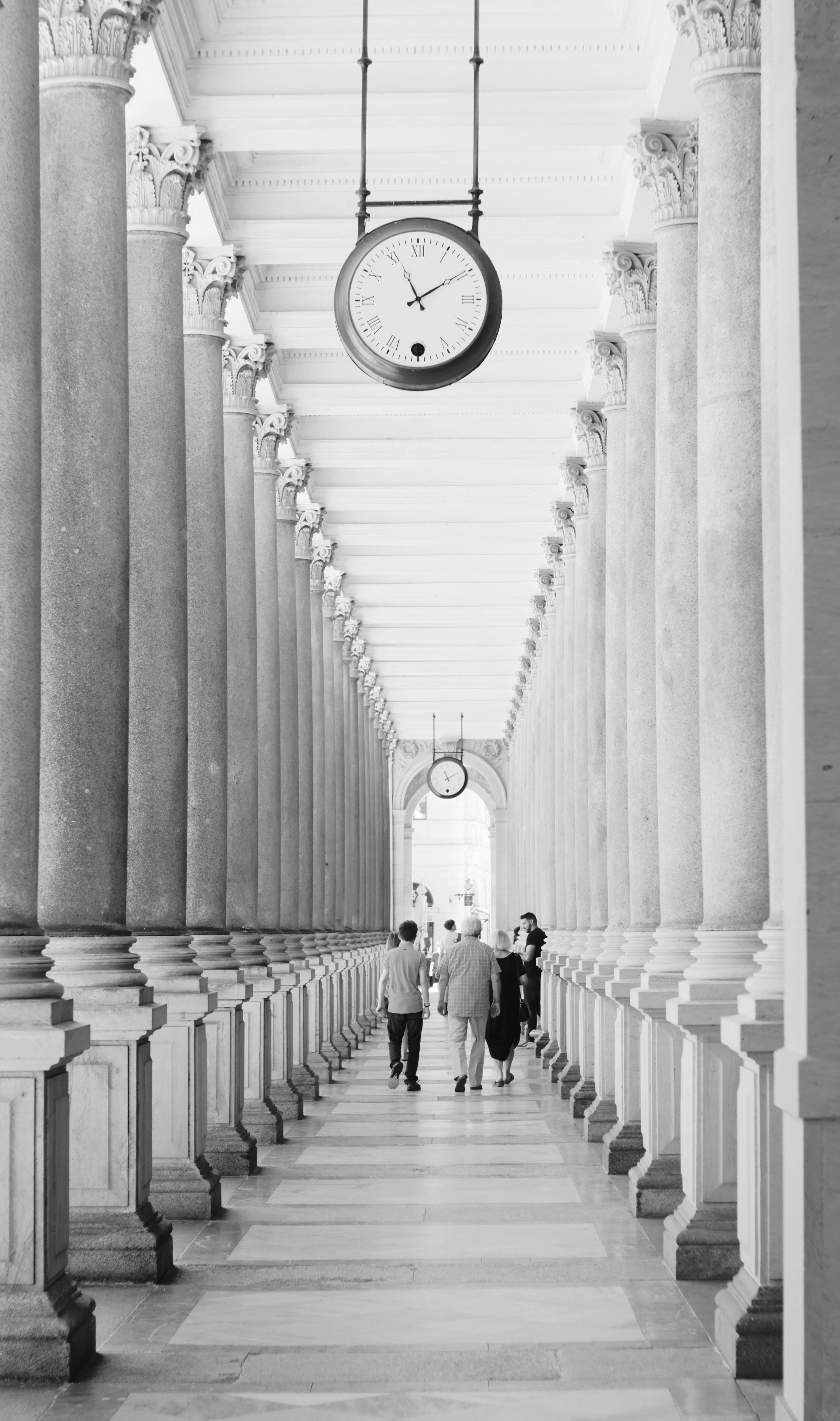 Monochrome view of a classic colonnade with ornate columns in Karlovy Vary, Czech Republic.