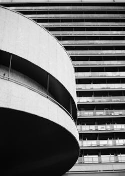 Abstract view of a modern skyscraper facade in Karlovy Vary, Czech Republic, captured in monochrome.