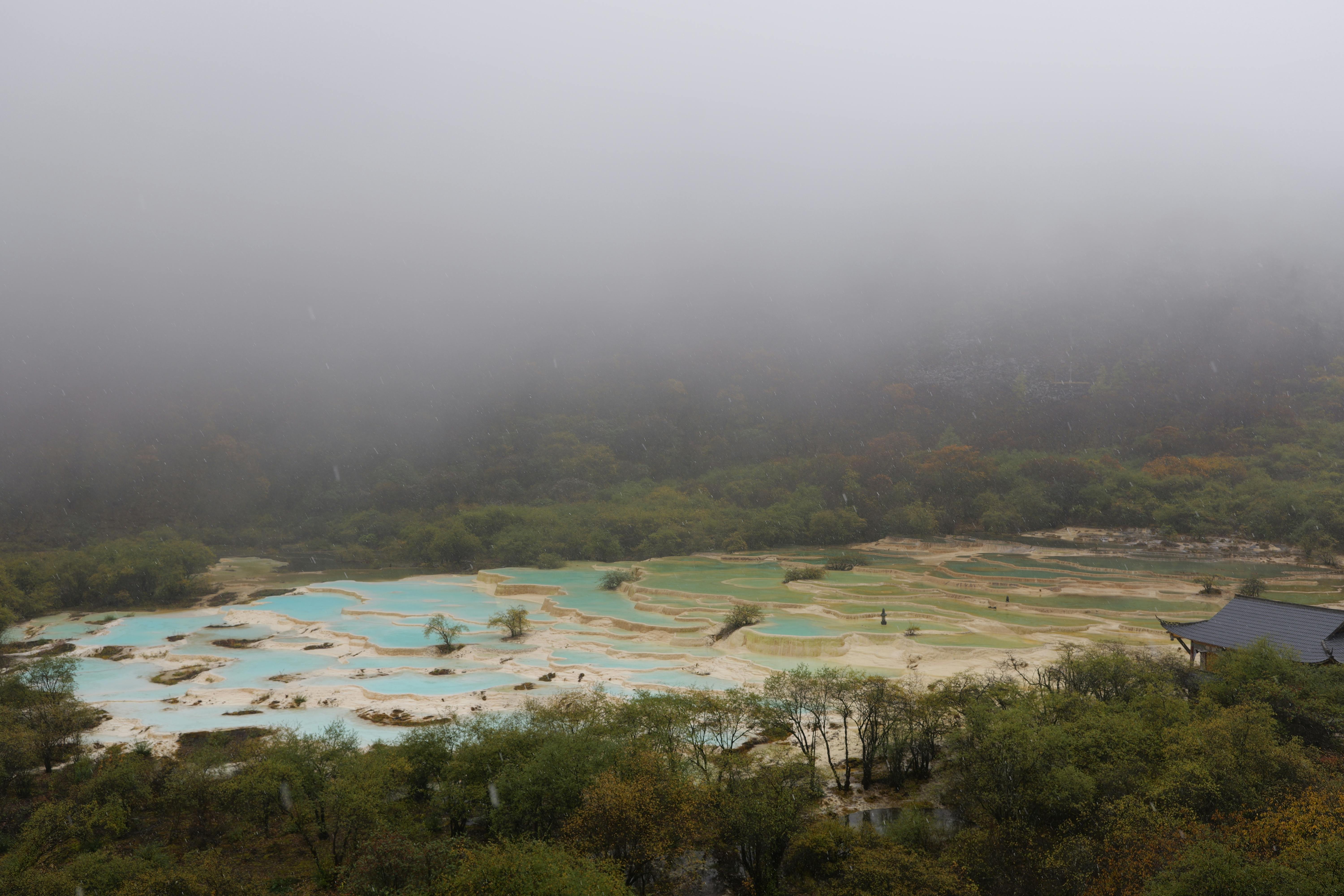 the misty landscape of a hot spring in the mountains