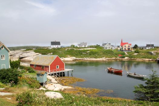 Idyllic summer view of boats and colorful houses in Peggy's Cove, Canada.