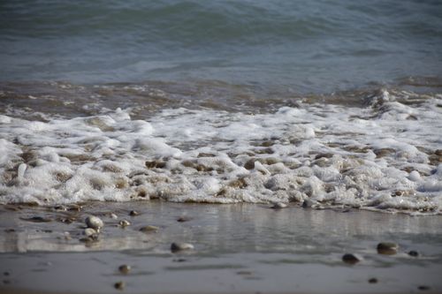 Free Serene ocean waves crashing on a rocky beach in Antalya, Turkey. Stock Photo