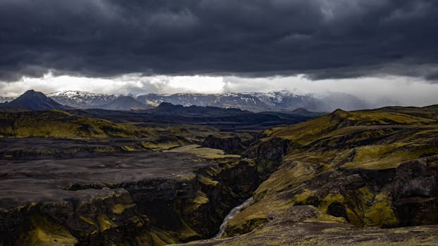 Majestic view of Icelandic mountains under dramatic clouds during twilight.