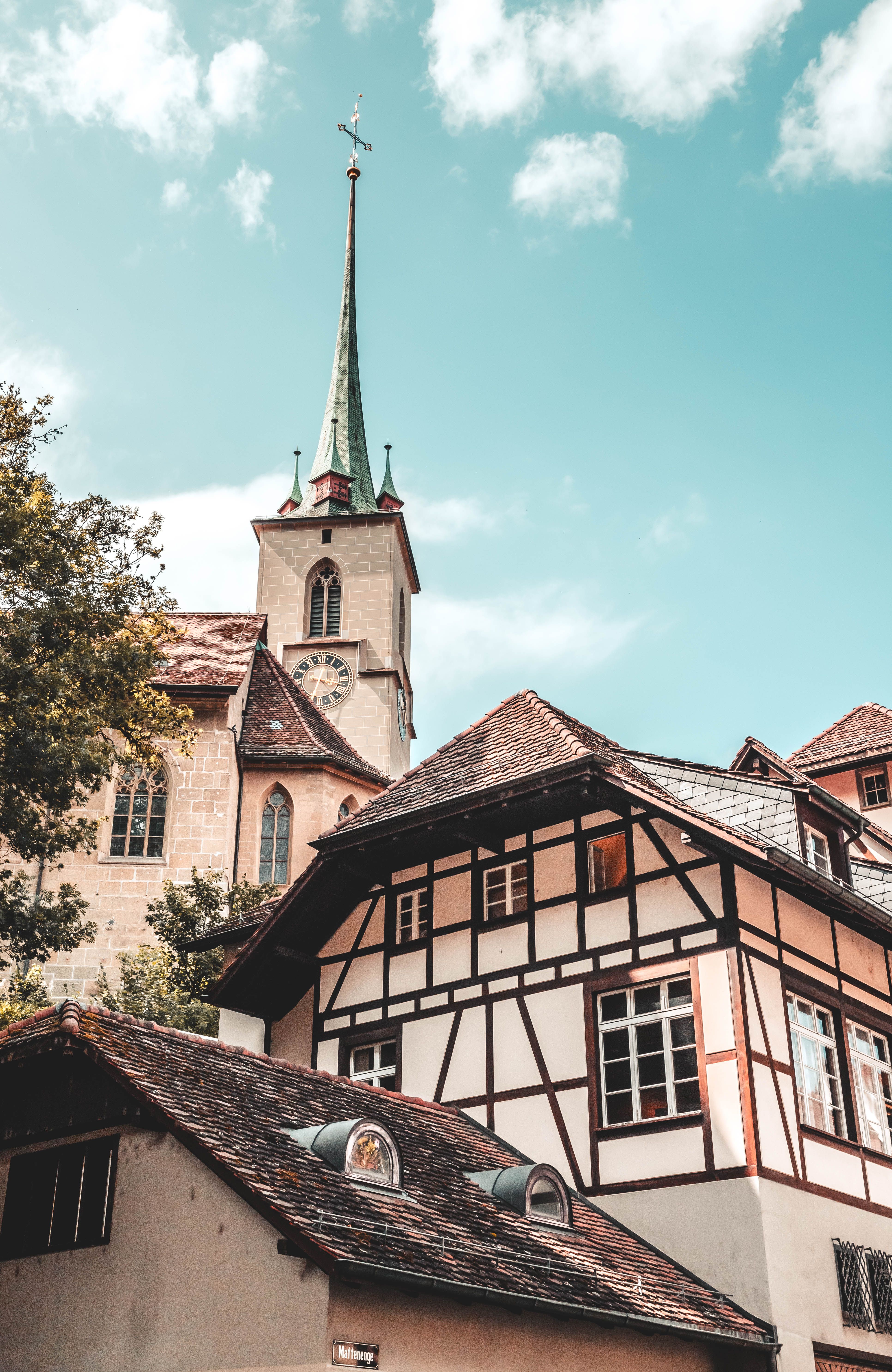 A church and a building with a steeple · Free Stock Photo