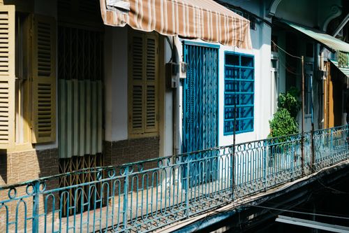 Free Vibrant colonial-style building facade in Ho Chi Minh City, Vietnam with colorful shutters and railings. Stock Photo