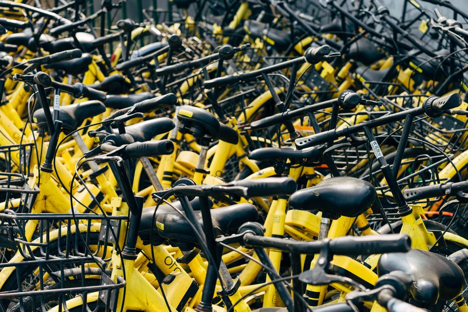 A dense collection of yellow rental bicycles parked outdoors in Peking, China.