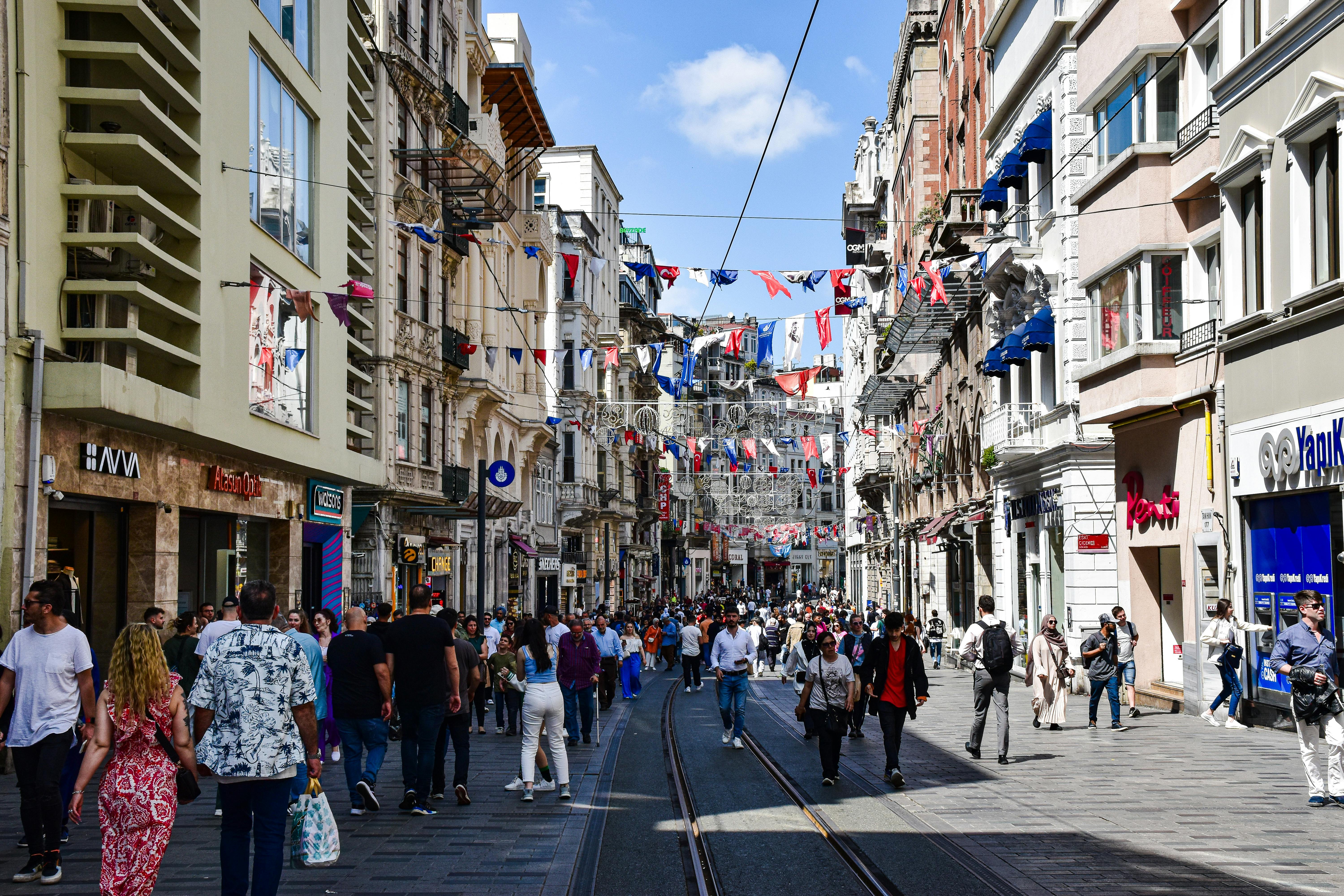 a city street with people walking and cars driving