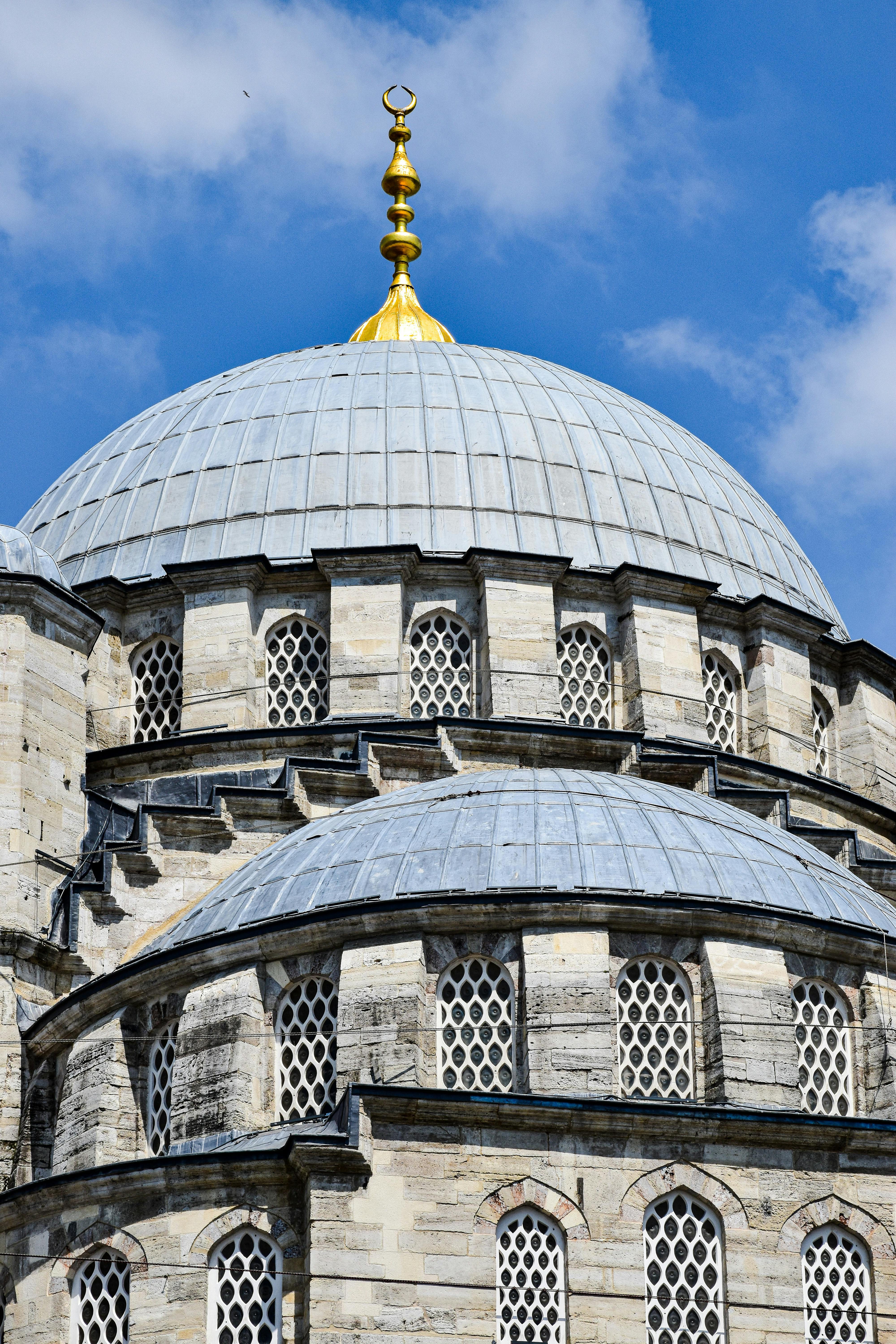 a large dome with gold domes and a clock