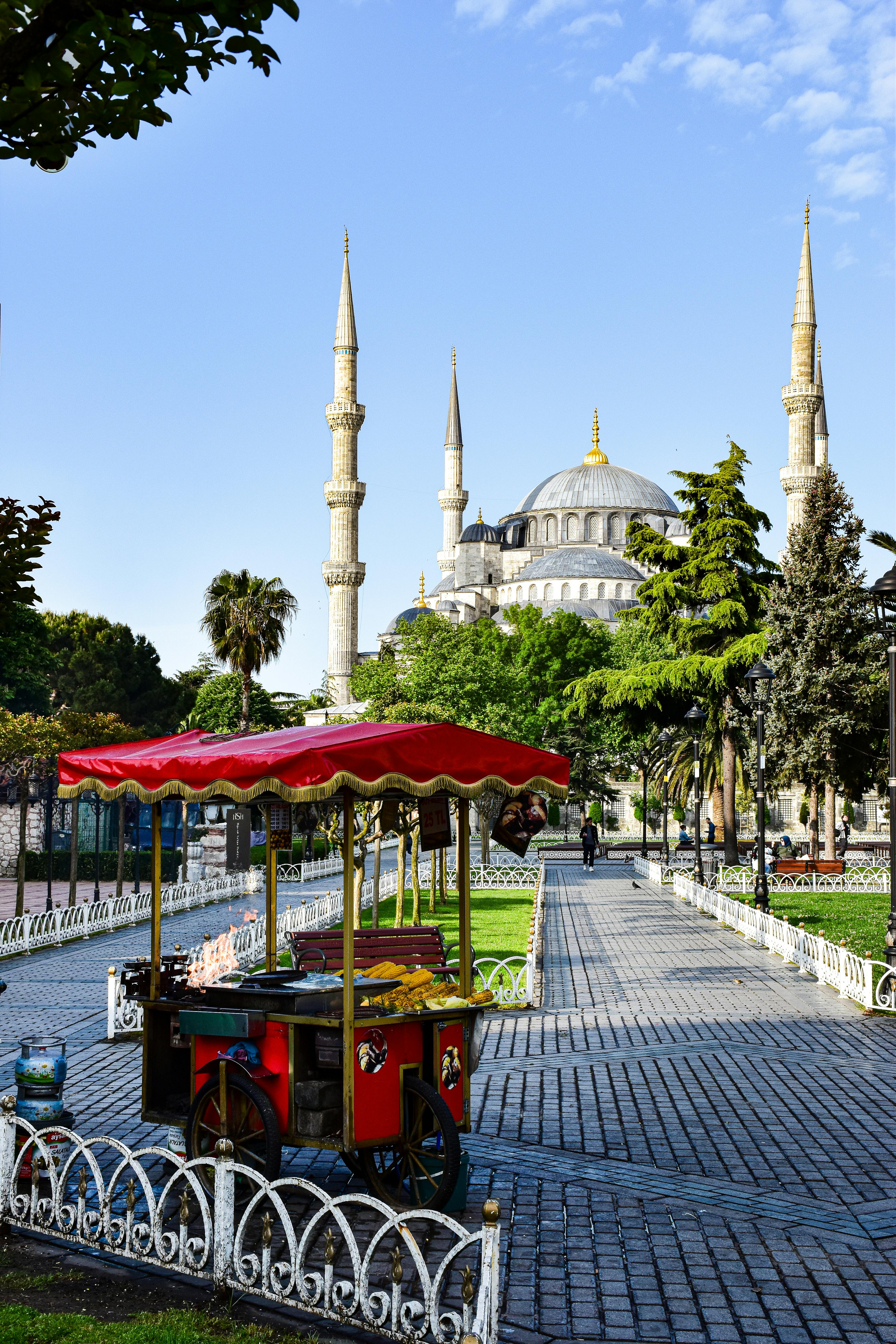 a cart with a sign that says tourist in front of a mosque