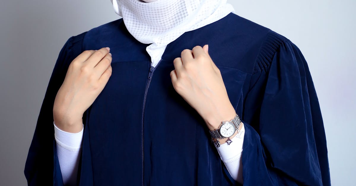 A woman in a graduation gown posing for a photo