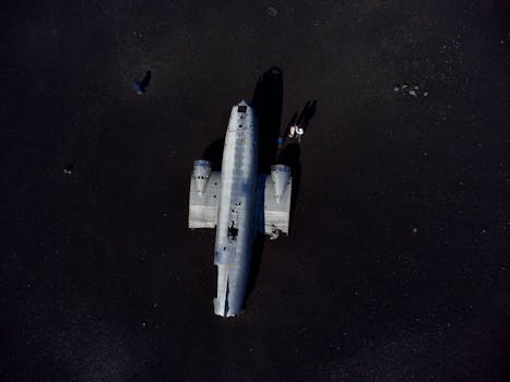 Aerial shot of a plane wreck on a barren landscape in Iceland.