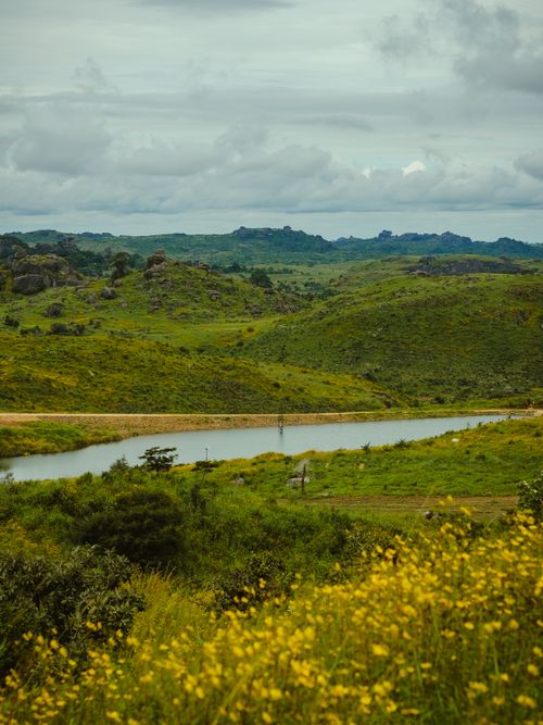 Free Beautiful landscape in Jos, Nigeria showcasing lush green hills and a serene lake under a cloudy sky. Stock Photo