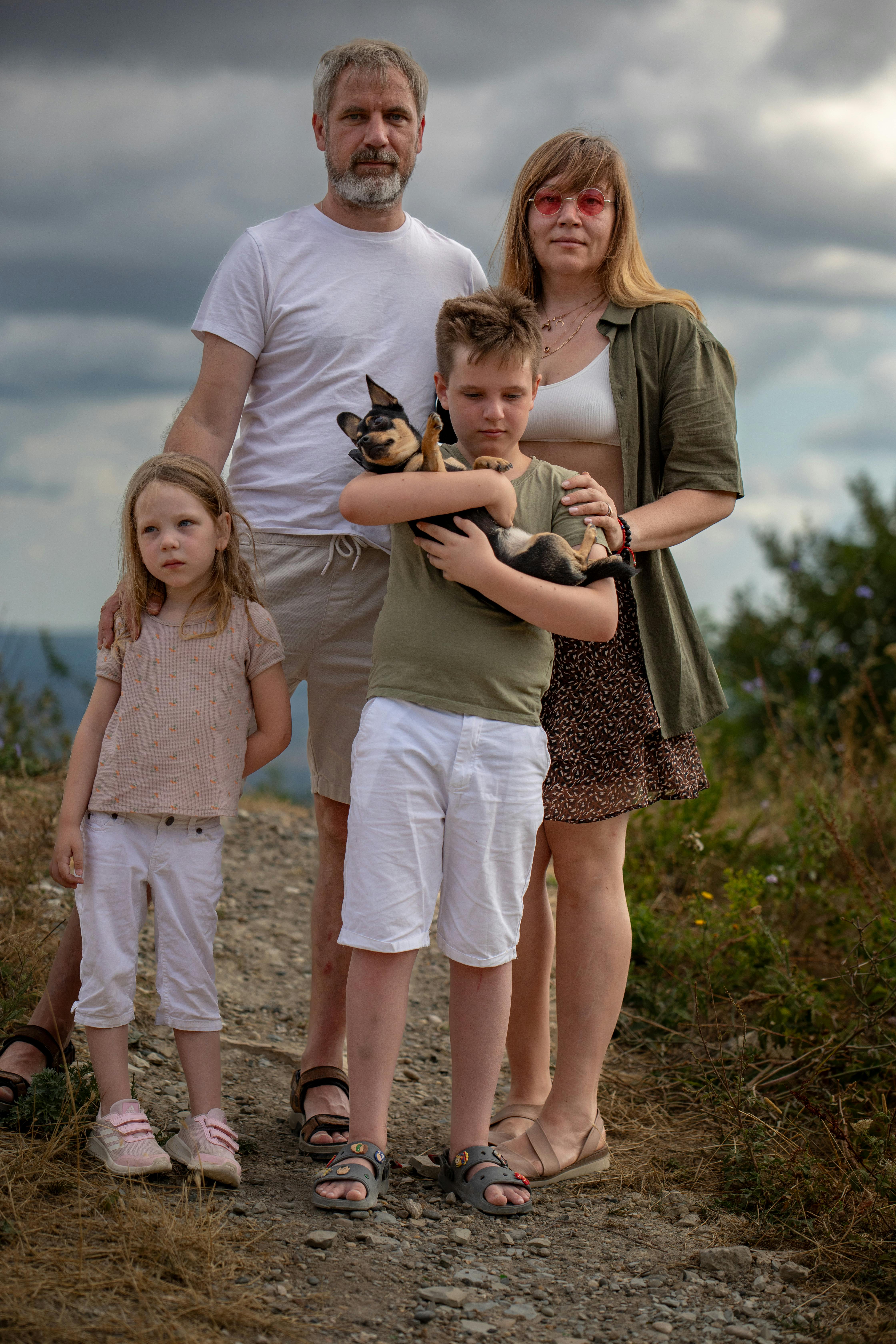 a family poses for a photo on a hill