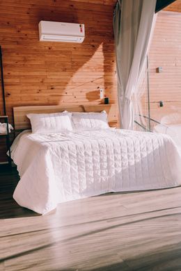 Bedroom with a double bed and white linen — Alexander Mass on Pexels