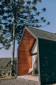 Charming wooden cabin set against a tranquil mountain backdrop, perfect for relaxation and escape.