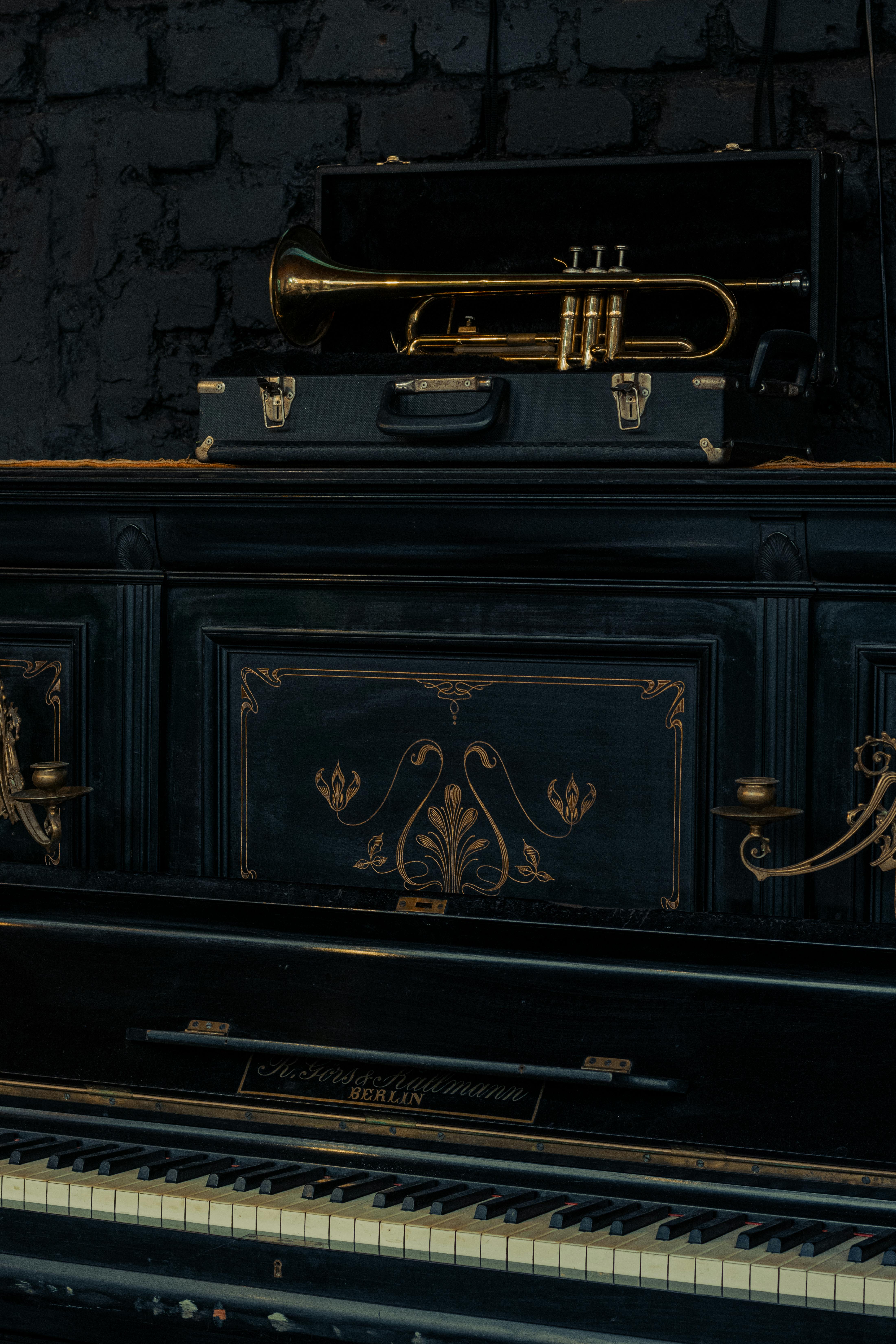 An elegant grand piano with a brass trumpet, epitomizing classical music charm in Chillán, Chile.