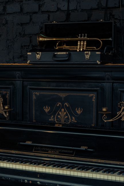 An elegant grand piano with a brass trumpet, epitomizing classical music charm in Chillán, Chile.